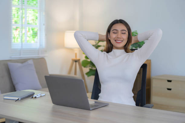 istock Adorable young Asian woman working with laptop at her comfortable working space. 2057511742