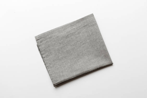 istock top view with gray kitchen napkin isolated on table background. Folded cloth for mockup with copy space, Flat lay. Minimal style 2057524486