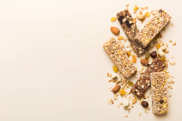 istock Various granola bars on table background. Cereal granola bars. Superfood breakfast bars with oats, nuts and berries, close up. Superfood concept 2057525028