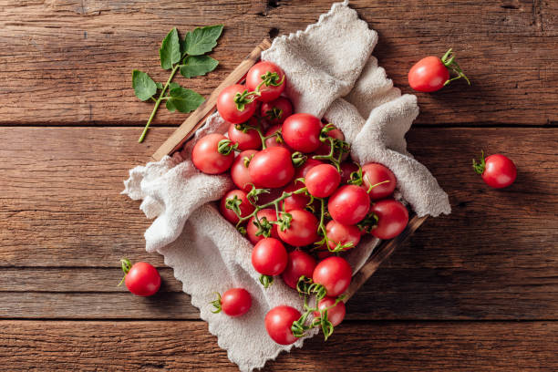 fresh tomato on wooden background stock photo