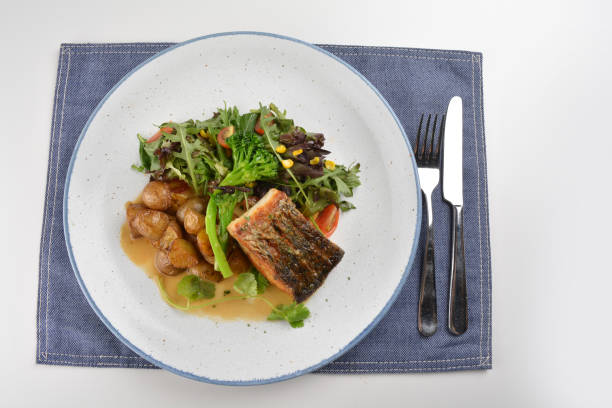 istock pan fried bbq fresh cod, salmon, grouper fish fillet in chef sauce with potato, corn and vegetables in plate on white table restaurant luxury hotel western cafe halal menu 2057543083