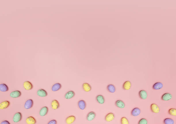 istock Top view of colourful easter eggs on pink background. 2057543650
