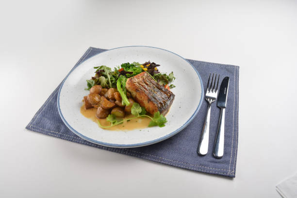 istock pan fried bbq fresh cod, salmon, grouper fish fillet in chef sauce with potato, corn and vegetables in plate on white table restaurant luxury hotel western cafe halal menu 2057544190