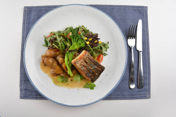 istock pan fried bbq fresh cod, salmon, grouper fish fillet in chef sauce with potato, corn and vegetables in plate on white table restaurant luxury hotel western cafe halal menu 2057544727