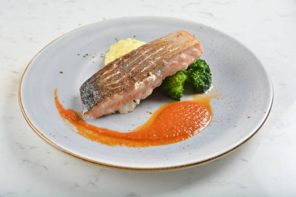 istock pan fried bbq fresh cod, salmon, grouper fish fillet in chef sauce with potato, corn and vegetables in plate on white table restaurant luxury hotel western cafe halal menu 2057546480
