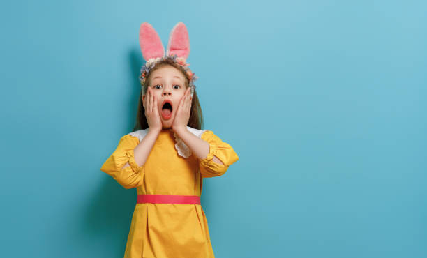 istock child wearing bunny ears on Easter day 2057549170