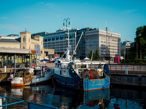 two small trawlers came to an anchor in a city harbour