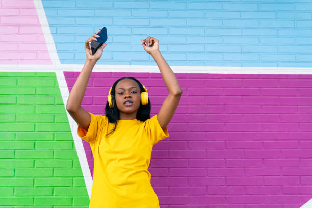 istock Energetic Afro-American Woman Dancing by Multicolored Wall 2057557072
