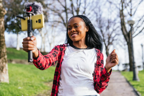 Vibrant Young Afro-American Female Vlogger Filming in Sunlight