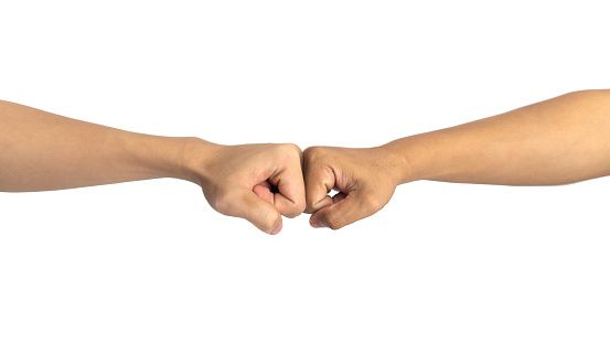 close up of a fist bump against isolated on white background