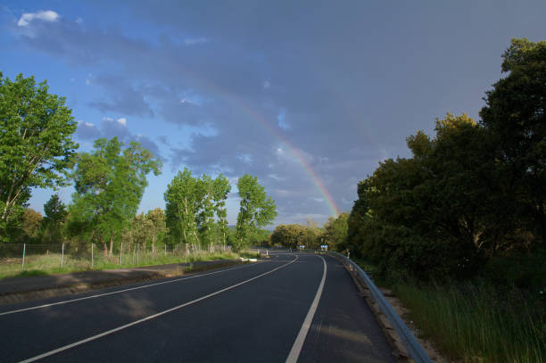 Rainbow over field road