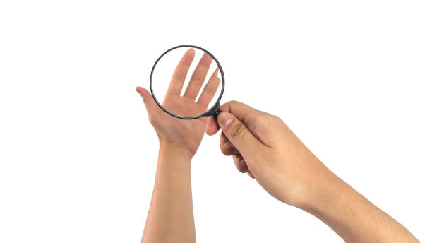 istock Woman hand hold a magnifier isolated on white. 2057581948