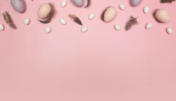 istock Top view of easter eggs, feathers on pink background. 2057598925
