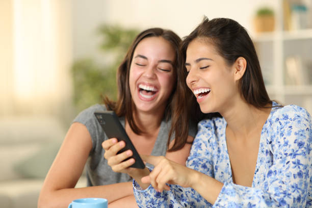 istock Funny friends laughing checking phone 2057605194
