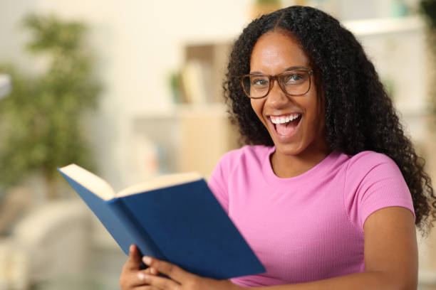 istock Happy black reader with eyeglasses looks at you 2057609935