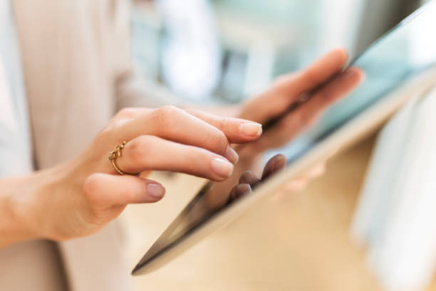 istock Unrecognisable young businesswoman in an office using digital tablet 2057614278