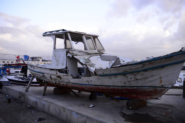 Ravda, Bulgaria - May 29, 2021: A man dismantling the Aurelia Shipwreck at the seaside resort village of Ravda, Nessebar municipality, Burgas Province for scrap