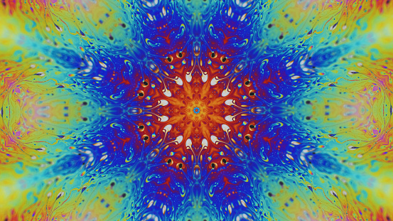 Lotus mandala. Ink kaleidoscope. Meditation energy. Defocused neon purple green blue orange color glowing paint water floral ornament motion abstract art background.