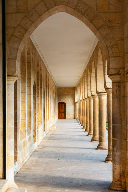 istock Oriental architecture corridor perspective ends to a door with columns and arches. 2057648185