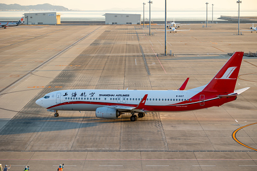 Tokoname, Japan - December 25, 2023 : Shanghai Airlines Boeing 737-800 at the Chubu Centrair International Airport in Tokoname City, Aichi Prefecture, Japan.