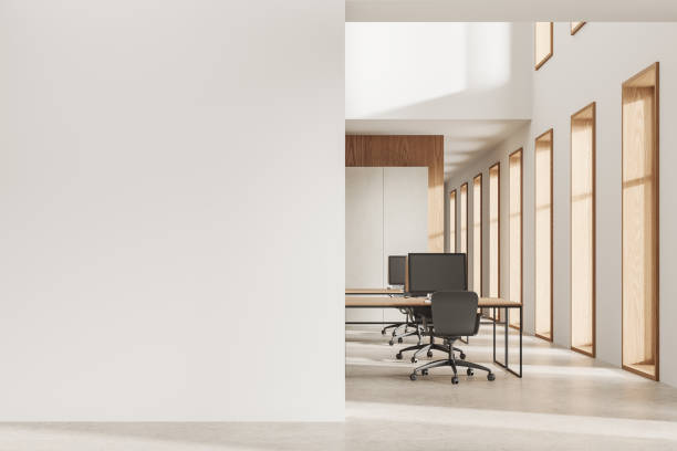 istock Cozy modern coworking interior with pc computers on desk, mockup wall 2057670156