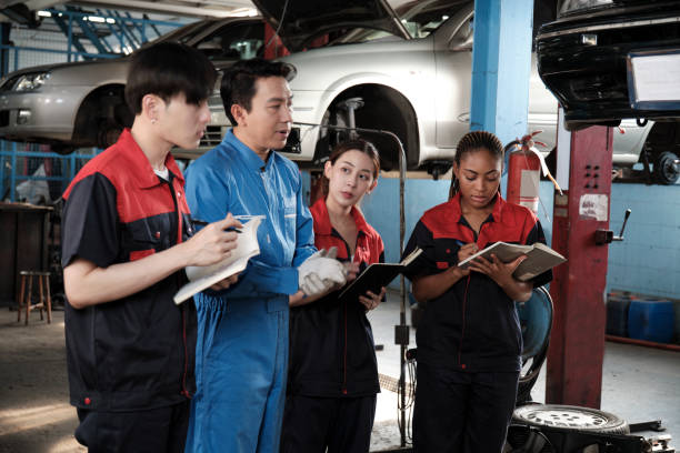 istock A supervisor engineer is training mechanic workers about car repair at a garage. 2057673954