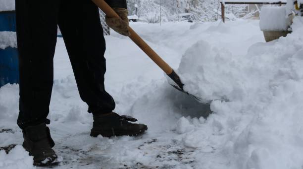 istock Human legs that removes the snow with a shovel 2057676102