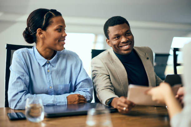 istock Smiling black businesspeople having a meeting, talking with some clients. 2057680584