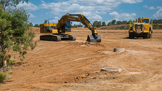 Yarrawonga, Victoria, Australia - 11 February 2022: Tracked excavator parked on a large dirt construction site in Yarrawonga