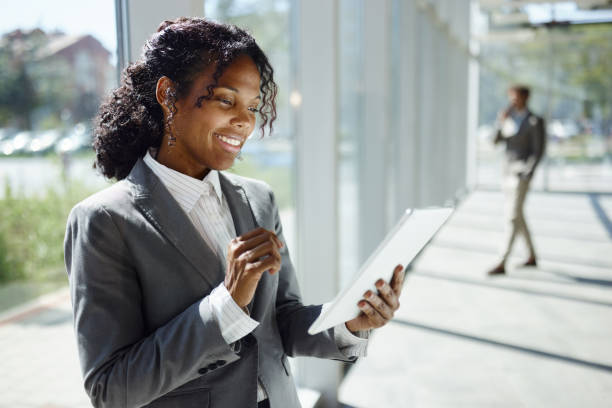 istock Happy black female entrepreneur using touchpad in a hallway. 2057724613