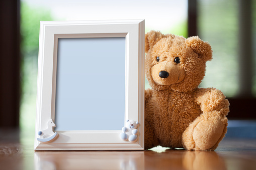 Empty photo frame with teddy bear. Photo frame with clipping path.
