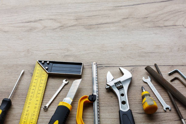 a set of hand tools on a wooden background. the concept of repair work. copy space - herramienta triangular fotografías e imágenes de stock