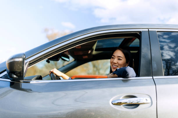 istock Well dressed beautiful woman driving car 2057734225