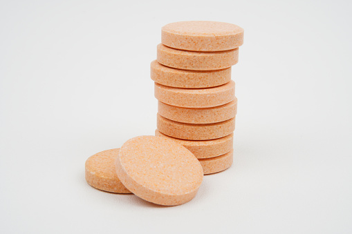 A stack of chewable vitamin c tablets concept background