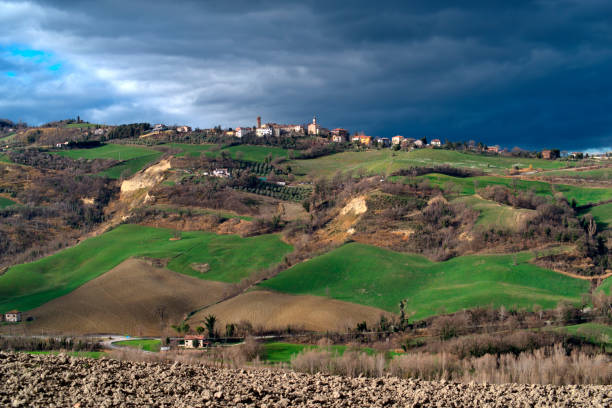 istock View of town on hill against cloudy sky 2057751675