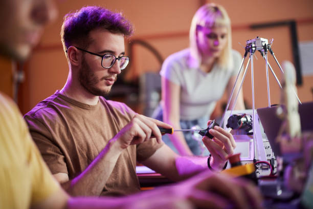 istock Male high school student working on computer chip in robotics laboratory. 2057753027