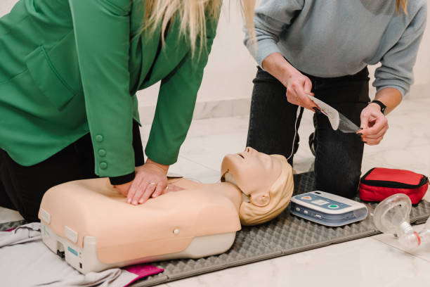 istock Indirect heart massage. Automated external defibrillator device, AED with training dummy mannequin. Use an automatic defibrillator in conducting basic cardiopulmonary resuscitation of victim. Closeup 2057756905