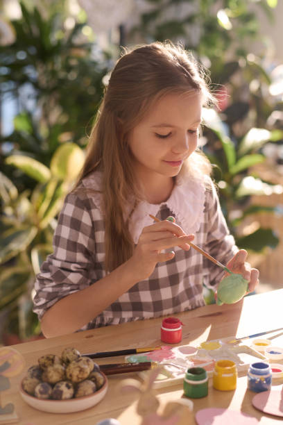 istock Happy Girl Coloring Eggs For Easter Holiday 2057759573
