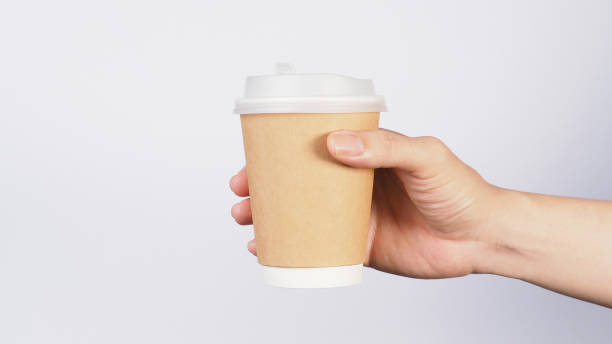 istock Hand is holding coffee cup isolated on white background. 2057780515