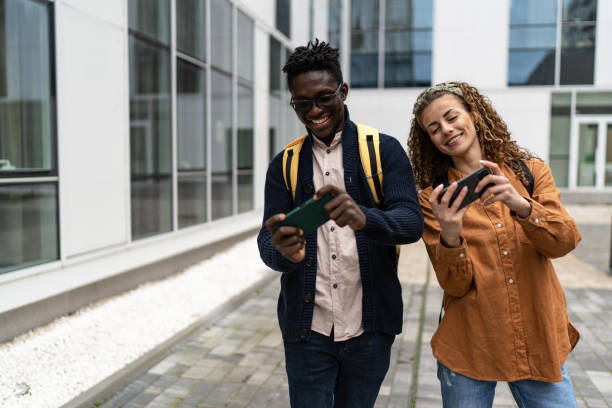 istock Smiling friends playing online game on smartphone 2057784797