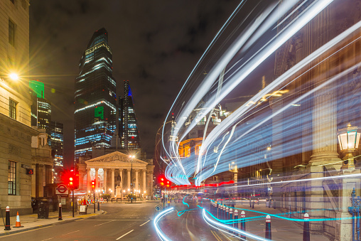 The Bank of England and skyscrapers of the City of London Square Mile financial district illuminated at night in the heart of London, the UK’s vibrant capital city.