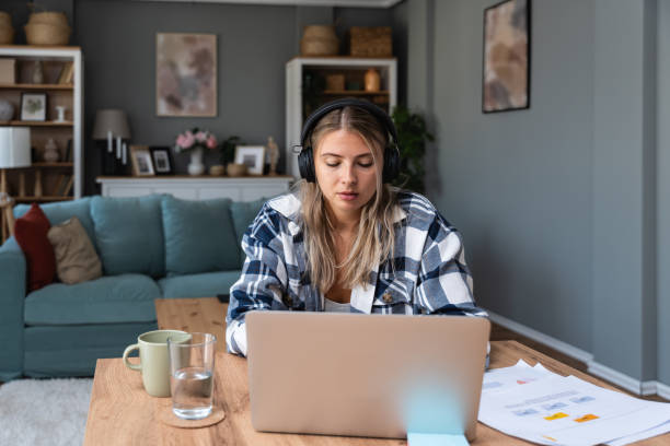 istock Side hustle money, second job concept. Young university student woman working freelance internet online job to pay student loan, saving money for rent, travel vacation Finance and economy video call 2057803563