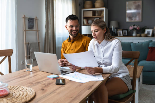 istock Side hustle money, second job concept. Young university students couple working freelance internet online job to pay student loan, saving money for rent, travel vacation Finance and economy video call 2057804626