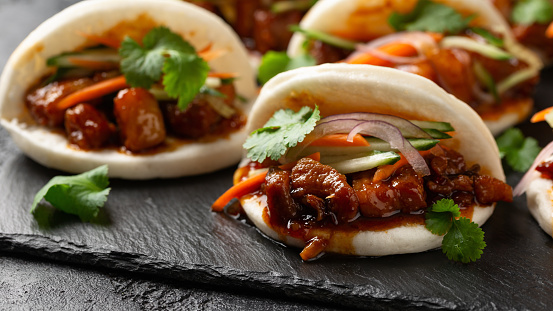 Bao buns with pork belly and vegetable. Asian cuisine.