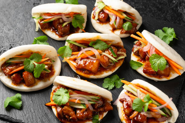 istock Bao buns with pork belly and vegetable. Asian cuisine 2057807789
