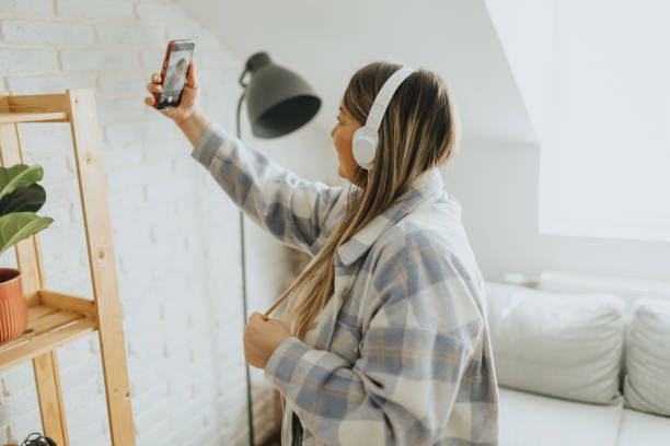 istock Beautiful young woman taking selfie at home 2057819468