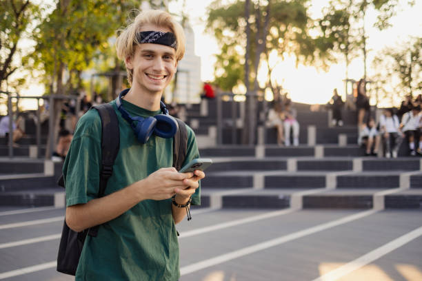 istock Happy male tourist enjoying while using mobile phone on the street. 2057823143