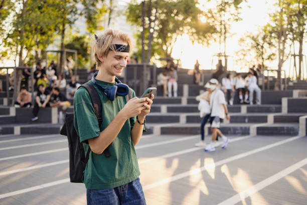 istock Happy college student using mobile phone on the move at the street. 2057823671