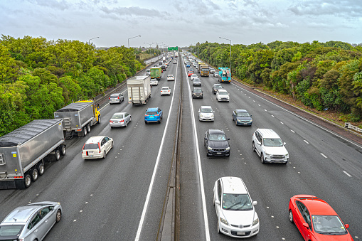 The heavy traffic on the motorway SH20 in Mangere in the rush hour in the afternoon on a rainy day