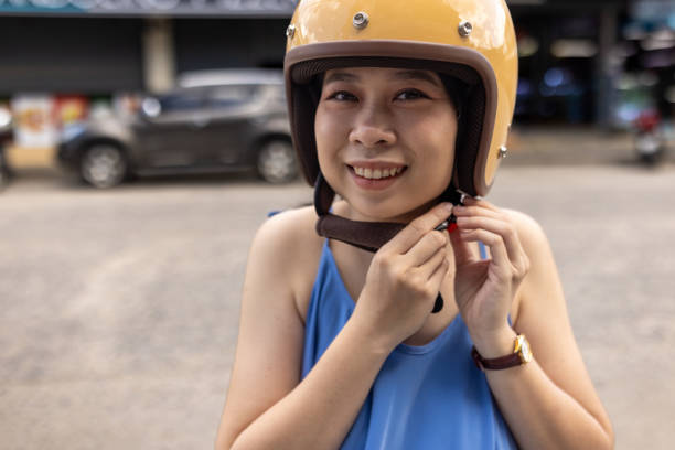 istock Woman putting on helmet 2057850431